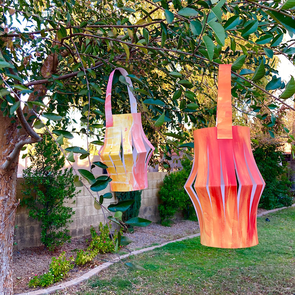 Chinese painted paper Lanterns hanging outside in garden